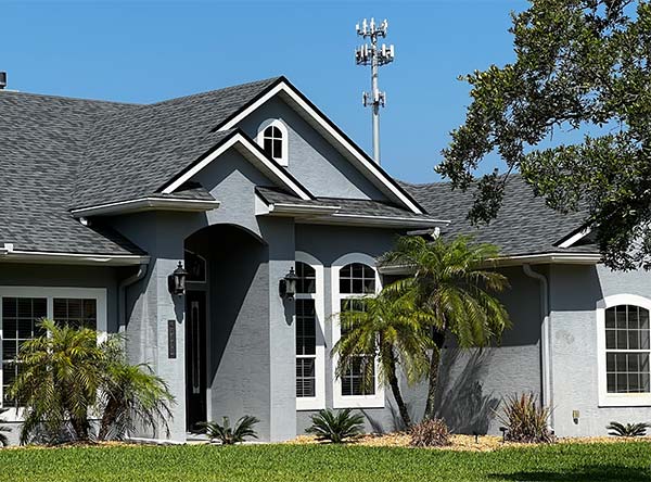 exterior of a home with a cell phone tower in the background